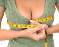 Picture of a woman measuring her reduced breasts